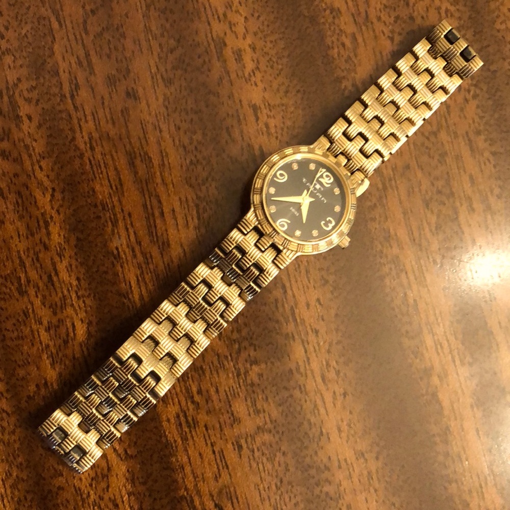 Tauan gold tone band black face Swiss watch